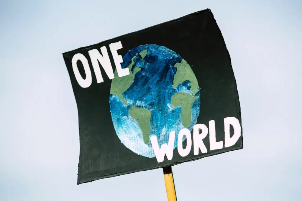 Schild: One World